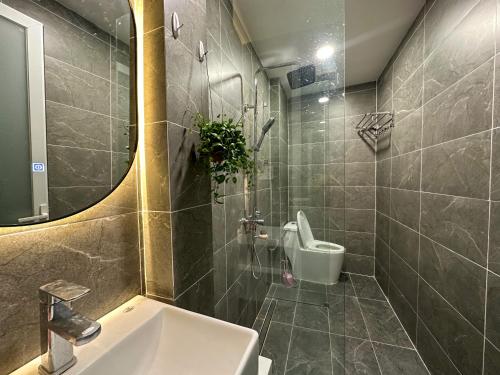 bagno con lavandino, servizi igienici e specchio di PVC Aparment, 1Brs in Dist 1 next to Bui Vien Street ad Ho Chi Minh