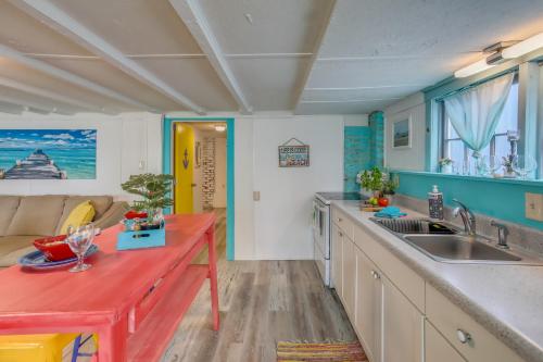 a kitchen with a sink and a red counter top at Colorful Murrells Inlet Gem with Outdoor Space! in Myrtle Beach