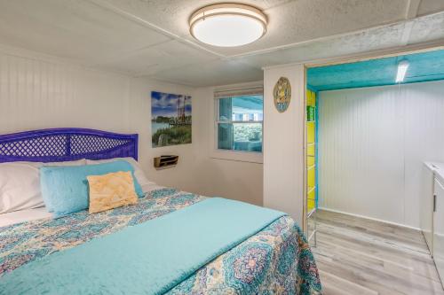 a bedroom with a blue bed and a window at Colorful Murrells Inlet Gem with Outdoor Space! in Myrtle Beach