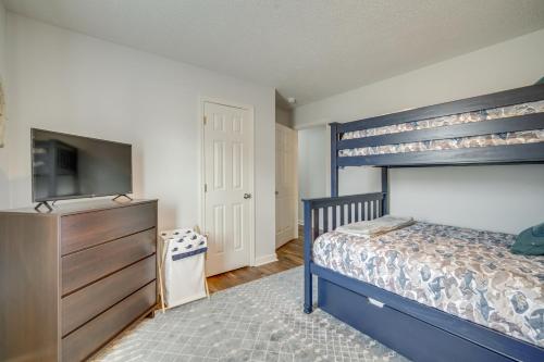 a bedroom with a bunk bed and a television at Pet-Friendly Villas Vacation Rental Walk to Bay in Rio Grande