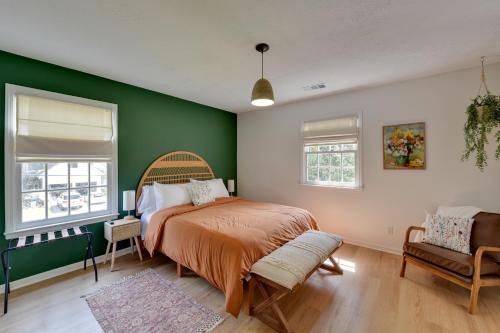 a bedroom with a bed and a green wall at Chic Georgia Getaway with Pool and Deck, Near Beaches! in Savannah