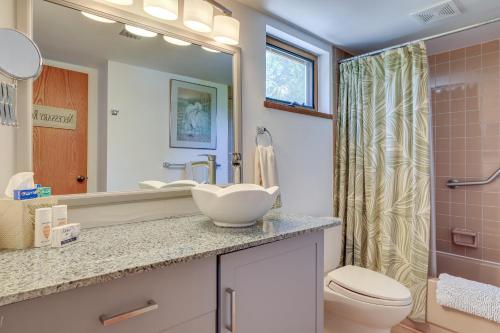 a bathroom with a sink and a toilet and a mirror at Scenic Siesta Key Home about 1 Mi to Village and Beach! in Siesta Key