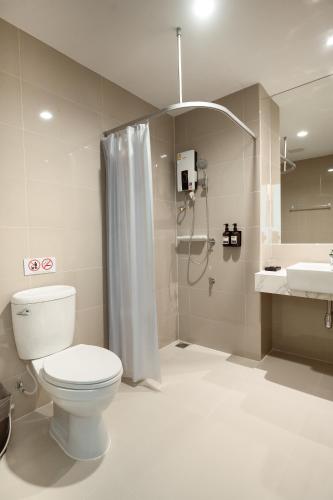 a bathroom with a toilet and a shower and a sink at Pillows boutique hotel in Chiang Mai