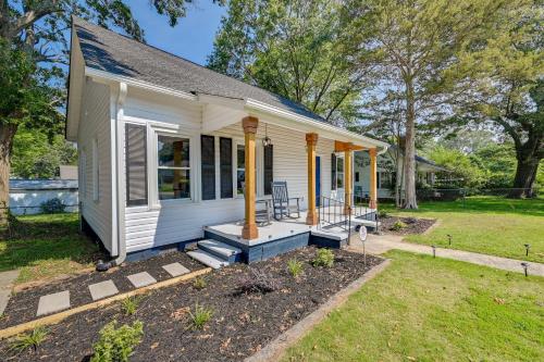 a small white house with a porch at Updated Greenville Home with Backyard! in Greenville