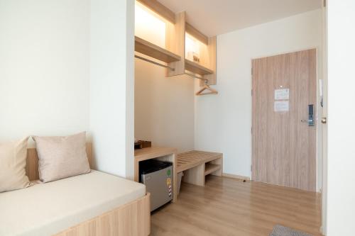 a small room with a bed and a desk at Pillows boutique hotel in Chiang Mai