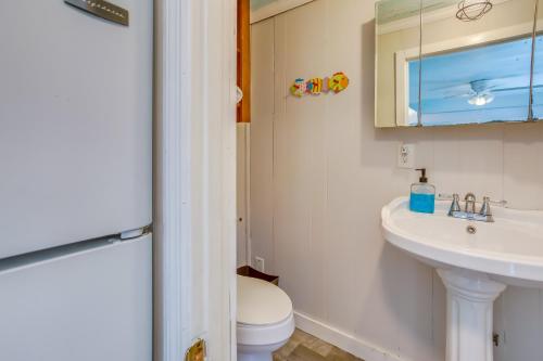 a bathroom with a sink and a toilet and a mirror at Murrells Inlet Apartment with Direct Beach Access! in Myrtle Beach