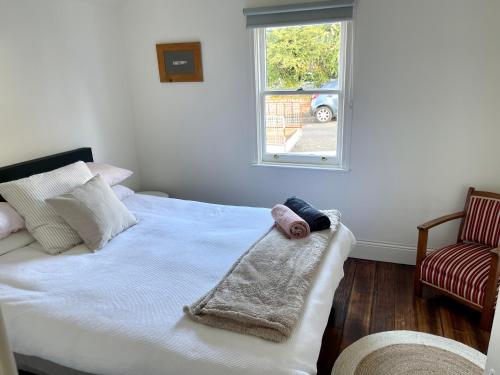 a bedroom with a bed with a baby on it at Heritage Cottage in Sandy Bay in Sandy Bay