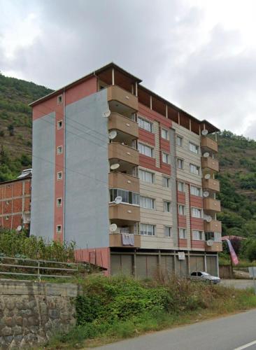 a large apartment building on the side of a road at Doğa manzaralı dere kenarında haftalık ve aylık in Macka