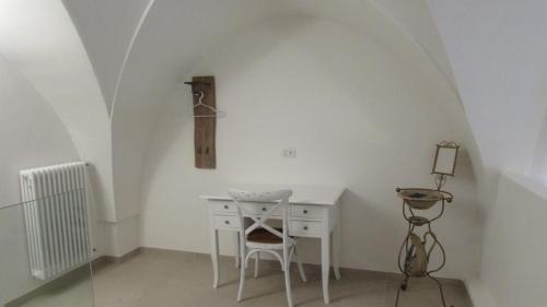 a white desk with a chair in a room at Palazzo Marisa in Fasano