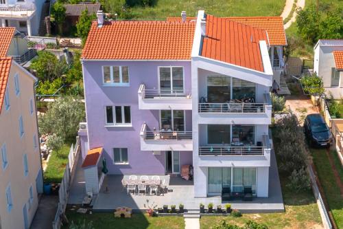 an aerial view of a purple house with an orange roof at KAIROS in Bilice