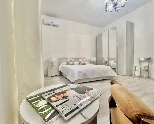 a bedroom with a bed and a table with a magazine at La Villetta nel Delta in Mesola