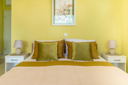 a bedroom with a large bed with two night stands at KAIROS in Bilice