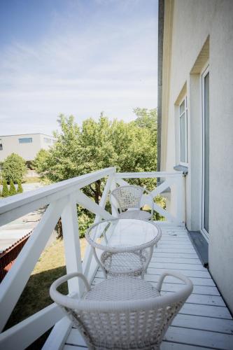 two chairs sitting on the porch of a house at Nautika Central Residence in Kuressaare
