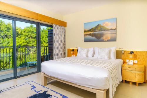 a bedroom with a bed and a large window at Ocean's Creek Beach Hotel in Balaclava