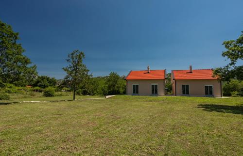 a house with a large yard in front of it at Country Homes Dujeva in Rijeka Crnojevića