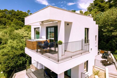 an aerial view of a white house with a balcony at Panorama Suite Dora with Jacuzzi in Palit
