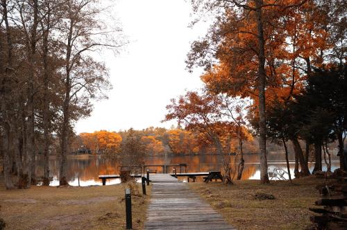 a wooden path leading to a lake with benches at Lakeside Hotels Kuore in Kitashiobara