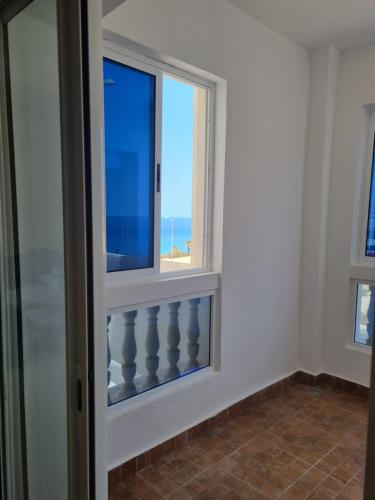 a window in a room with a view of the ocean at Appartement Al hoceima in Al Hoceïma