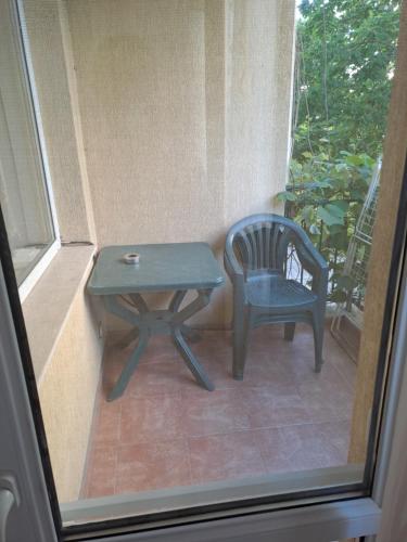 a table and a chair next to a window at Apartment See Breeze in Sunny Beach