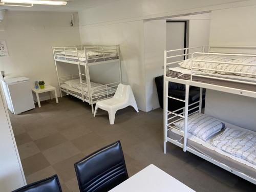 a room with bunk beds and a desk and a chair at Family rooms in the center in Grindsted