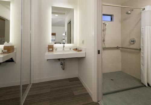 a bathroom with a sink and a shower at Fogcatcher Inn in Cambria