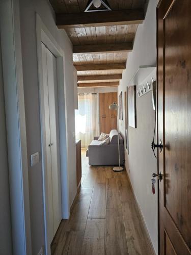 a hallway with a room with a bed in the background at Moda Apartments 69 in Sestriere