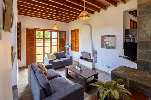 a living room with a couch and a table at The Olympians Villas in Polis Chrysochous