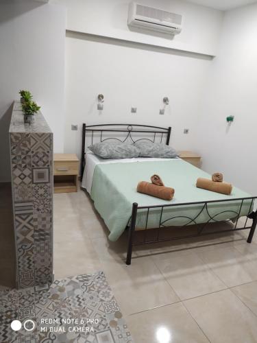 a bedroom with a bed with two towels on it at Villa Popi Studios in Kefalos