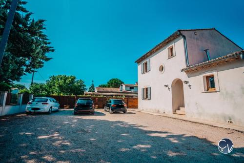 a house with cars parked in a driveway at Villa le Thor Piscine Billard Sauna et Jacuzzi in Le Thor