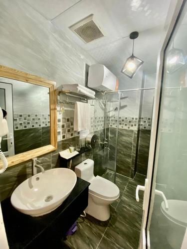 a bathroom with a sink and a toilet and a shower at Mia House DaLat Hotel - Bống Stay in Da Lat