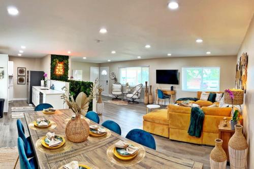 a living room with a table and a couch at NEW: Tulum Oasis in Denver w/ Hot Tub & Games in Denver