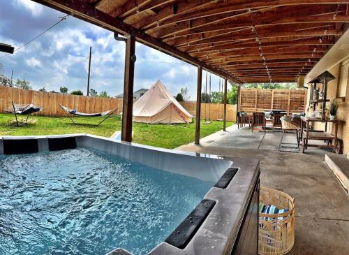 a swimming pool in a backyard with a tent at NEW: Tulum Oasis in Denver w/ Hot Tub & Games in Denver