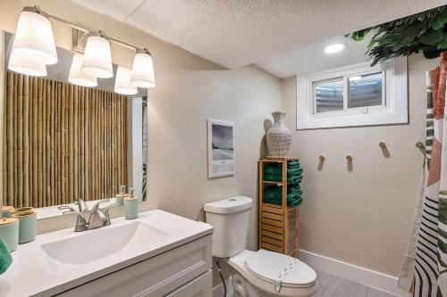 a bathroom with a sink and a toilet and a window at NEW: Tulum Oasis in Denver w/ Hot Tub & Games in Denver