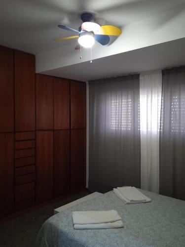 a bedroom with a bed and a ceiling fan at A casa di Maria in Rome