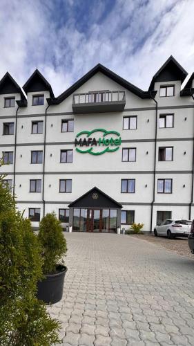 a large white building with a sign on it at MAFA Hotel in Bukovel