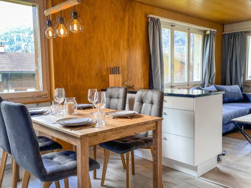 a dining room with a wooden table and chairs at Swiss Alps Lodge in Kandersteg