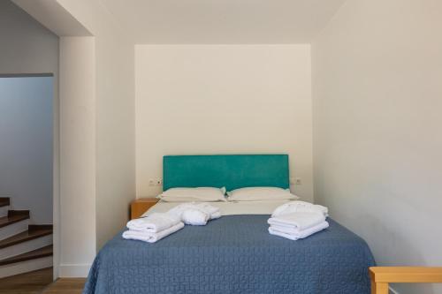 a bedroom with a bed with towels on it at Maris Villas in Elounda