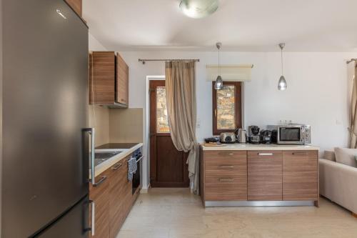 a kitchen with a refrigerator and a counter top at Maris Villas in Elounda