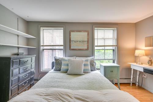 a bedroom with a large bed with two windows at Cozy Boston Vacation Rental with Rooftop Deck! in Boston