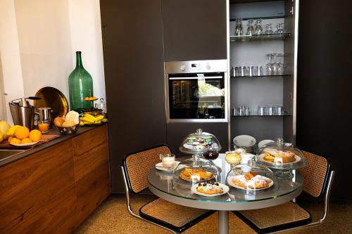 a table with food on it in a kitchen at Villa La Torretta Luxury B&B - Adults Only - in Rimini