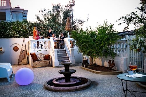 a group of people standing at a bar in a backyard at Villa La Torretta Luxury B&B - Adults Only - in Rimini