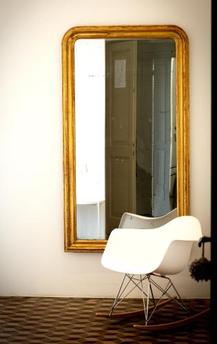 a white chair sitting in front of a mirror at Villa La Torretta Luxury B&B - Adults Only - in Rimini