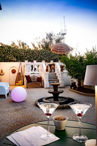 a table with two wine glasses on top of it at Villa La Torretta Luxury B&B - Adults Only - in Rimini