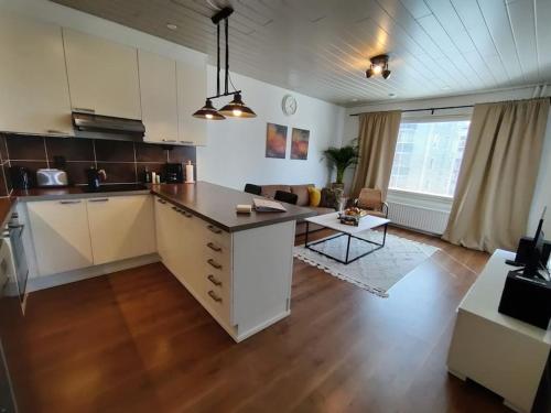an open kitchen and living room in a apartment at Private apartment near Ruissalo, Castle, Harbour - AC, Free parking in Turku
