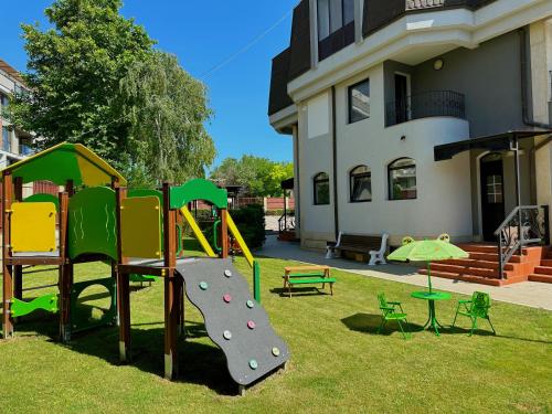 a playground in the yard of a house at Family Hotel Paradise in St. St. Constantine and Helena