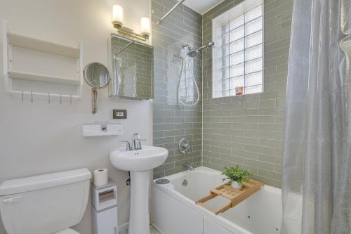 a bathroom with a sink and a toilet and a tub at Chicago Condo Laptop Workspace, 6 Mi to Downtown! in Chicago