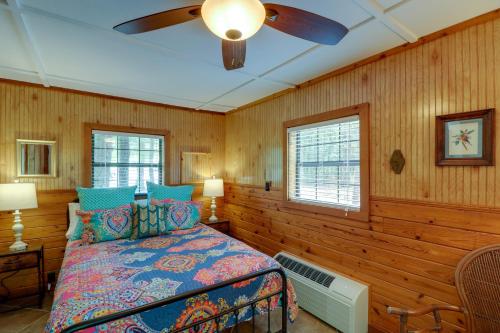 a bedroom with a bed and a ceiling fan at Arkansas Vacation Rental on Greers Ferry Lake! in Fairfield Bay
