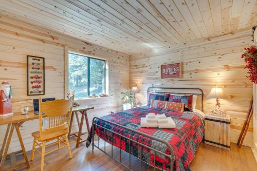 a log cabin bedroom with a bed and a desk at Charming Cabin Near Kirkwood Ski Resort with Hot Tub in Pioneer