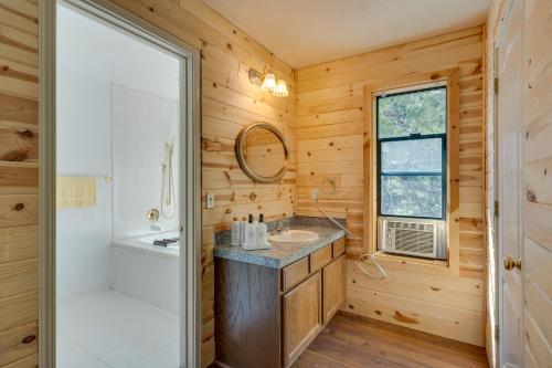 a bathroom with a shower and a sink and a mirror at Charming Cabin Near Kirkwood Ski Resort with Hot Tub in Pioneer
