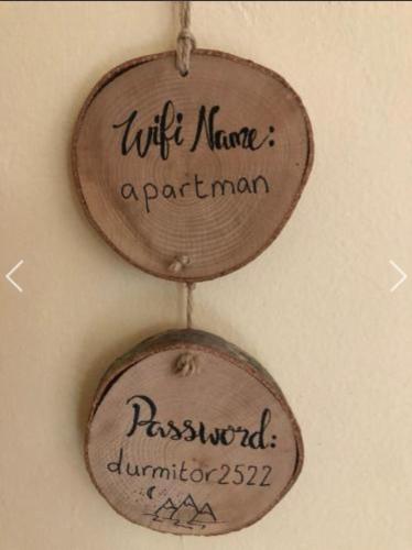 two wooden signs hanging on a wall at Apartment Žugić in Žabljak